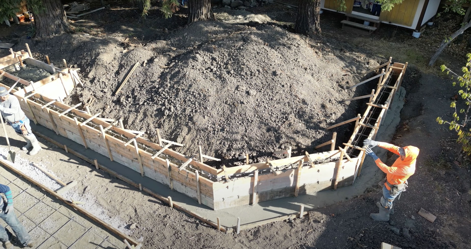 Professional foundation preparation with proper forming and reinforcement Concrete foundation preparation with wooden forms and reinforcement ready for pour